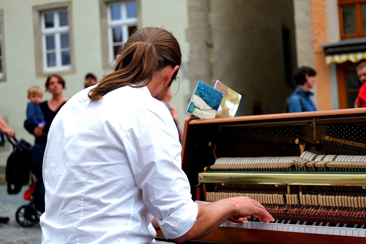Man playing piano outdoors