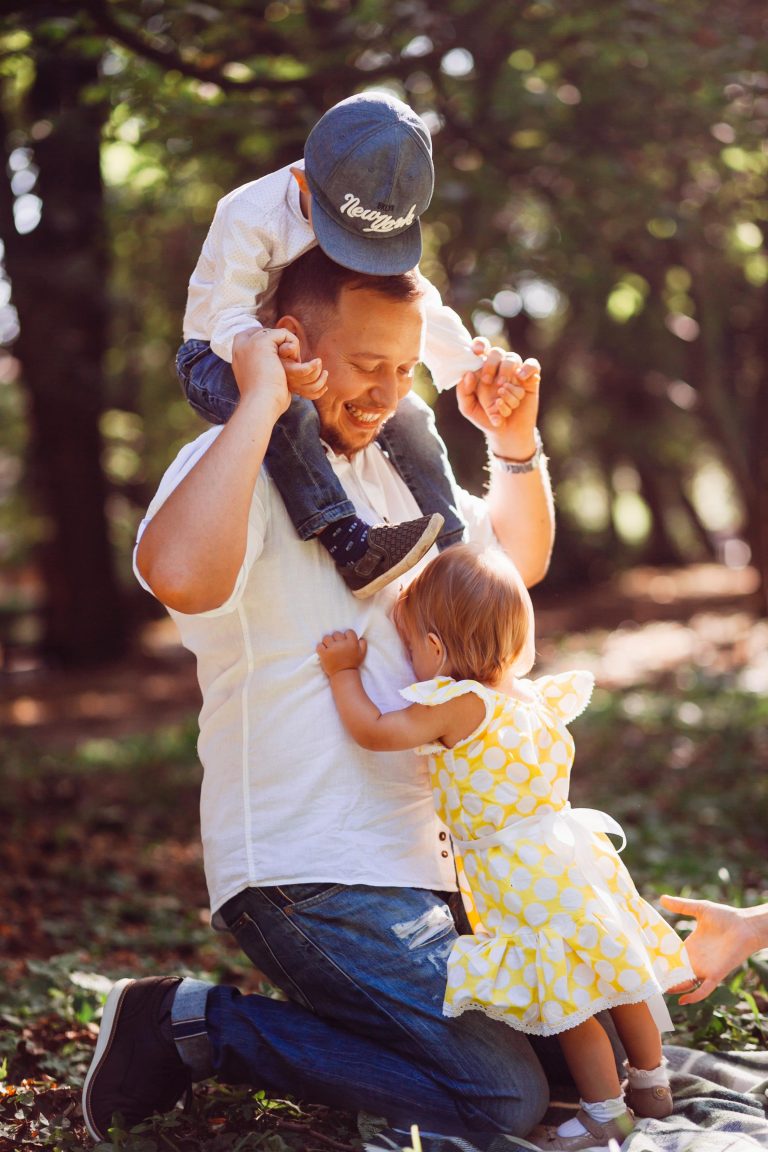 Father with two children on his shoulders